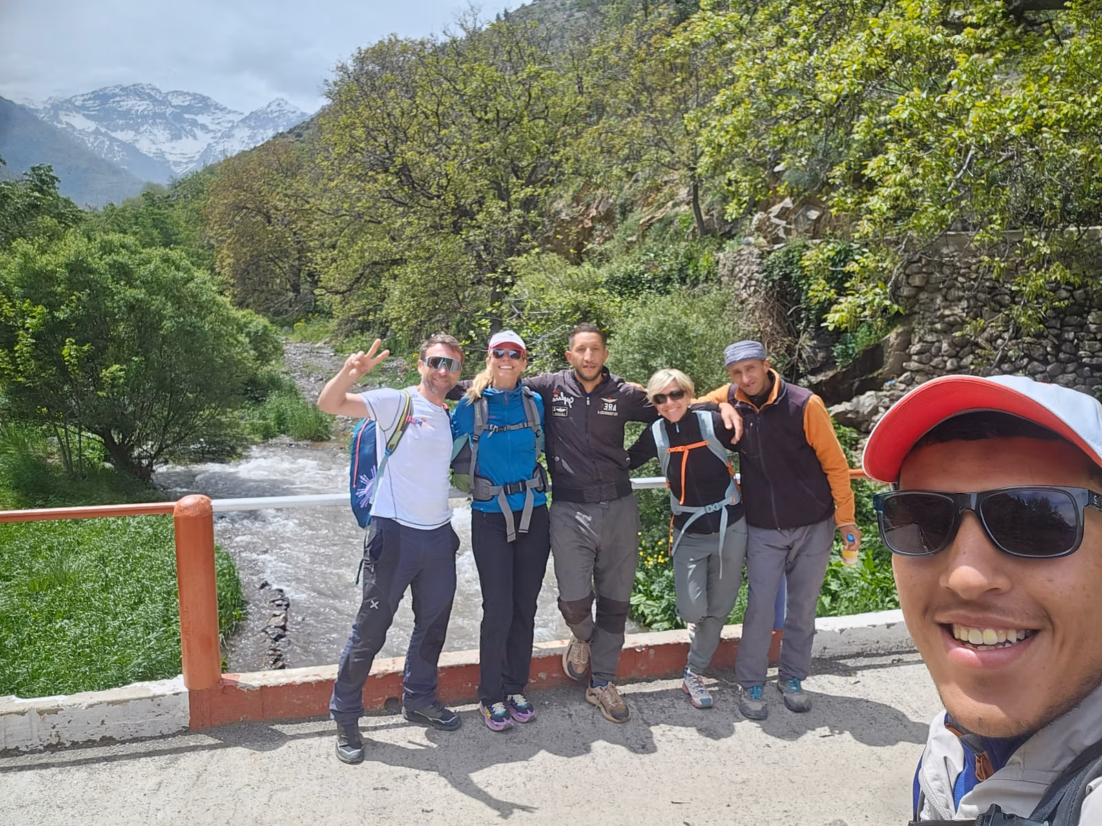 Group by river snow peaks selfie