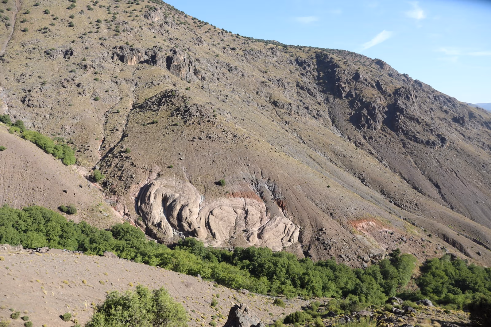 Folded rock strata mountainside