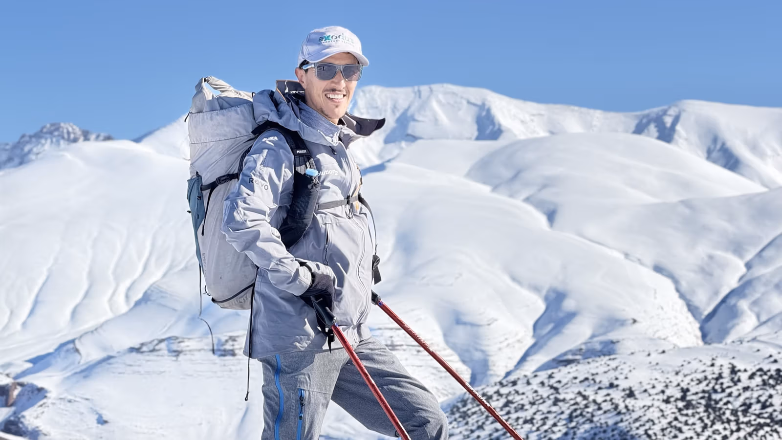 A ski tourer smiling on a snowfield in the High Atlas