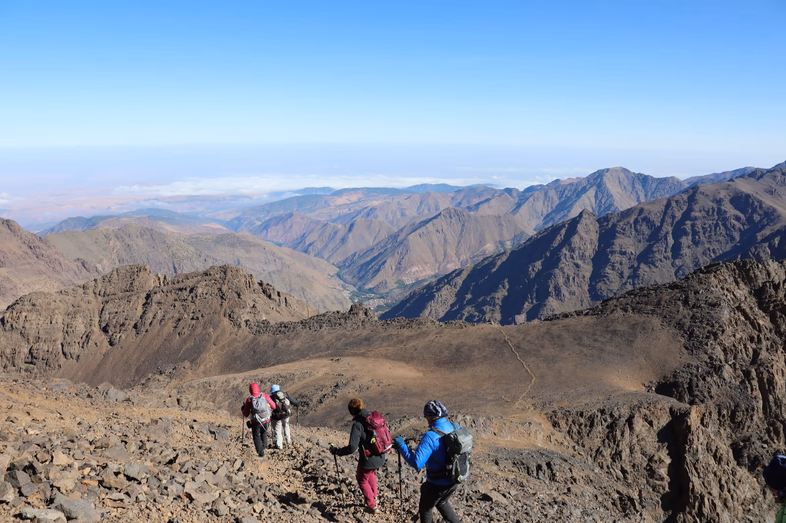 Trekkers crossing a High Atlas ridge